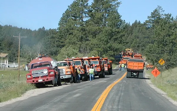 Fire trucks and emergency response vehicles - Circa 2002: the fire trucks and emergency response vehicles line up in preparation for stopping the fire from skipping the road and burning habitated woods.